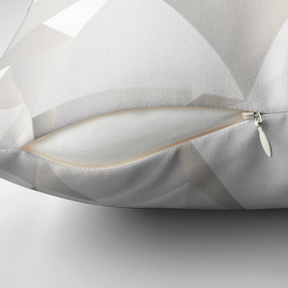Soft, grey decorative pillow with a modern pattern of lines, triangles, and butterflies