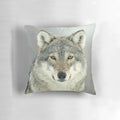 A grey wolf-inspired decorative throw pillow featuring a wilderness design