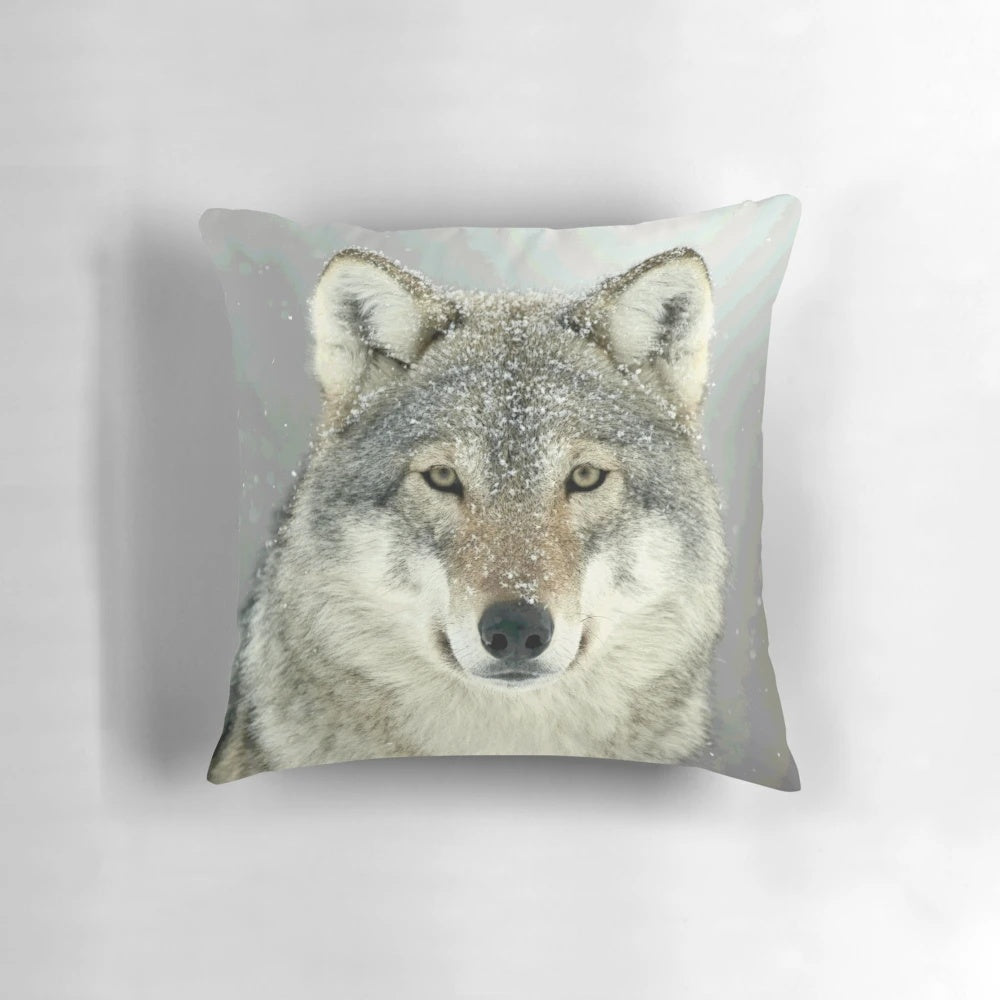 A grey wolf-inspired decorative throw pillow featuring a wilderness design
