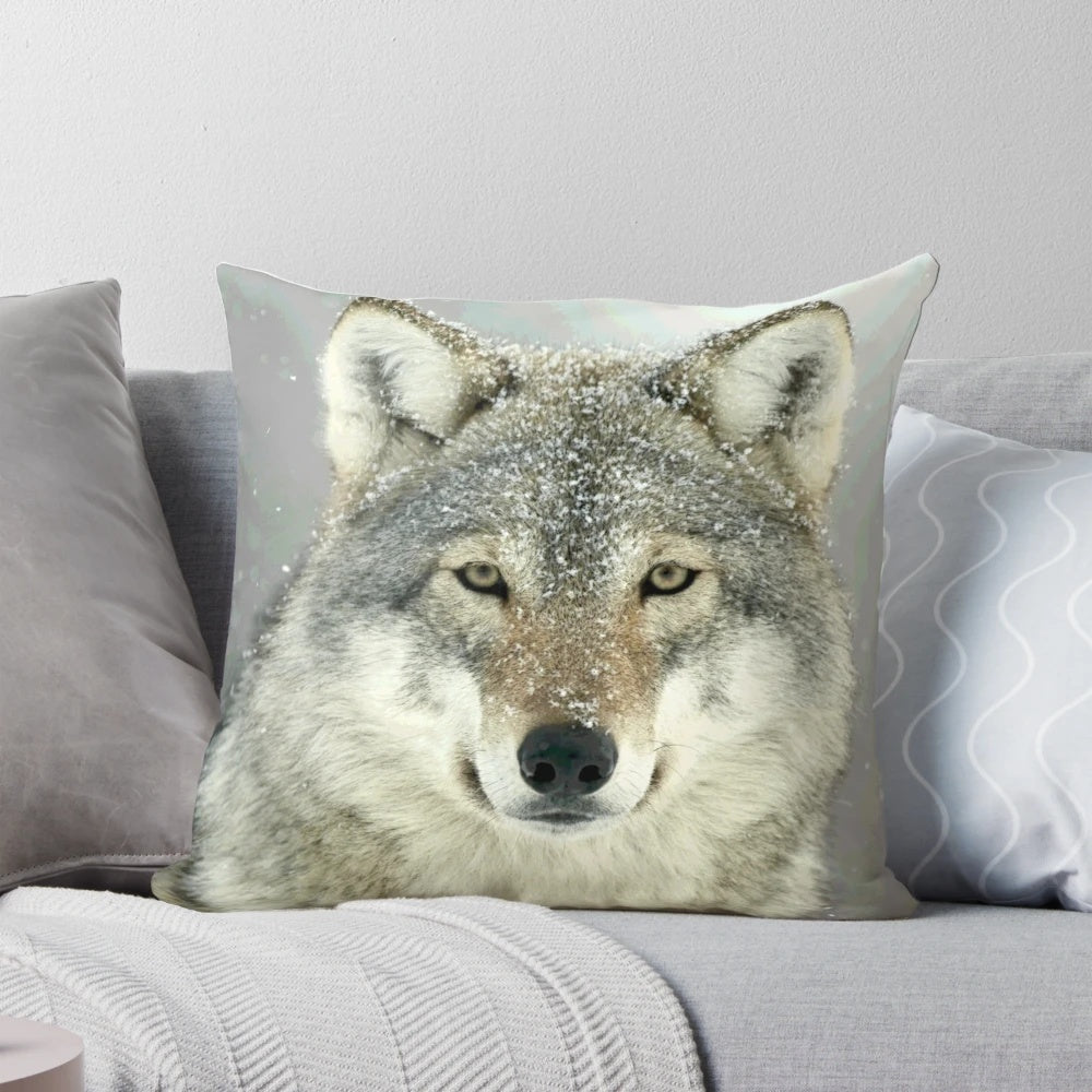 A grey wolf-inspired decorative throw pillow featuring a wilderness design