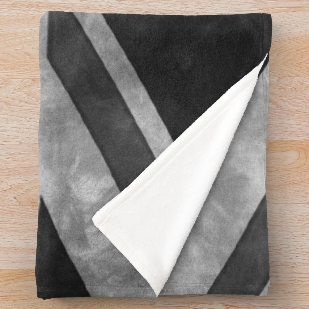 Greyscale plush blanket with distressed union jack design