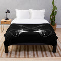 Plush blanket featuring a crossed guitar silhouette design