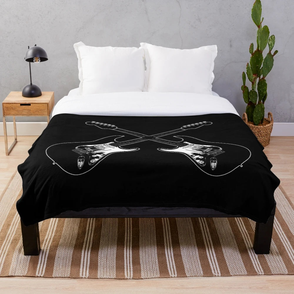 Plush blanket featuring a crossed guitar silhouette design