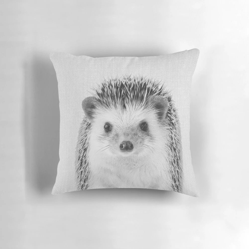 A black and white hedgehog portrait printed on a soft, plush pillow for a modern nursery or children's room.