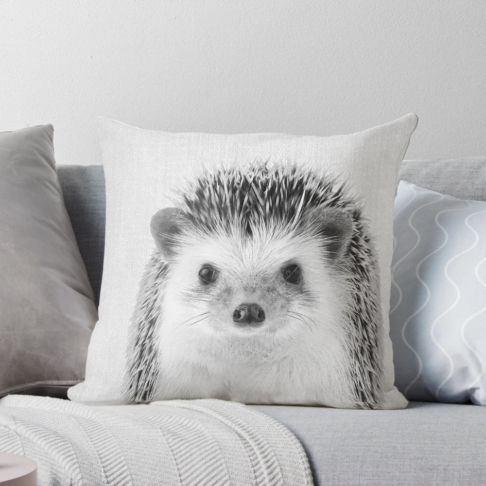 A black and white hedgehog portrait printed on a soft, plush pillow for a modern nursery or children's room.