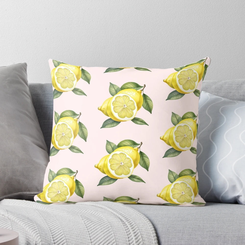A decorative pillow featuring a vibrant lemon design with green leaves on a yellow background.