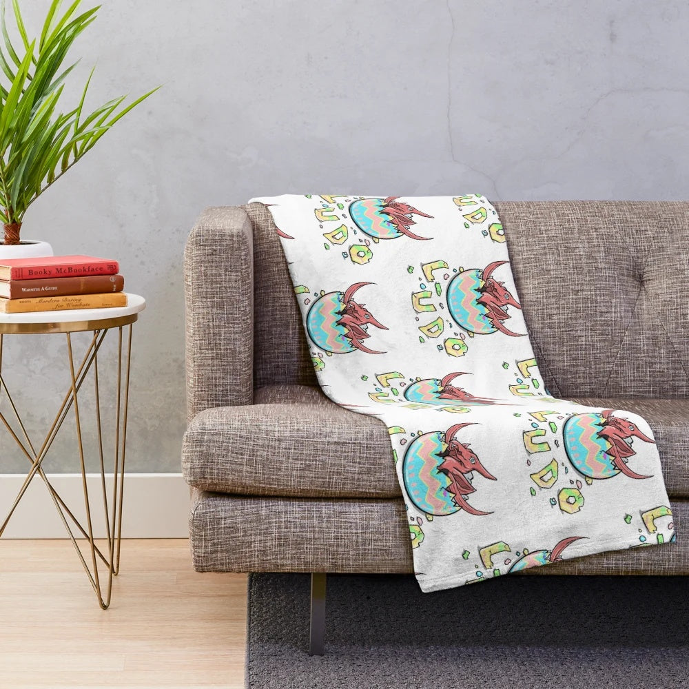 LUDO-inspired baby plush blanket featuring an Easter pterodactyl design