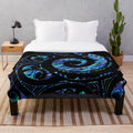 Plush blanket with a Maori-inspired paua tattoo koru design