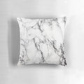 A modern, minimalist marble pattern design on a white pillow and phone case.
