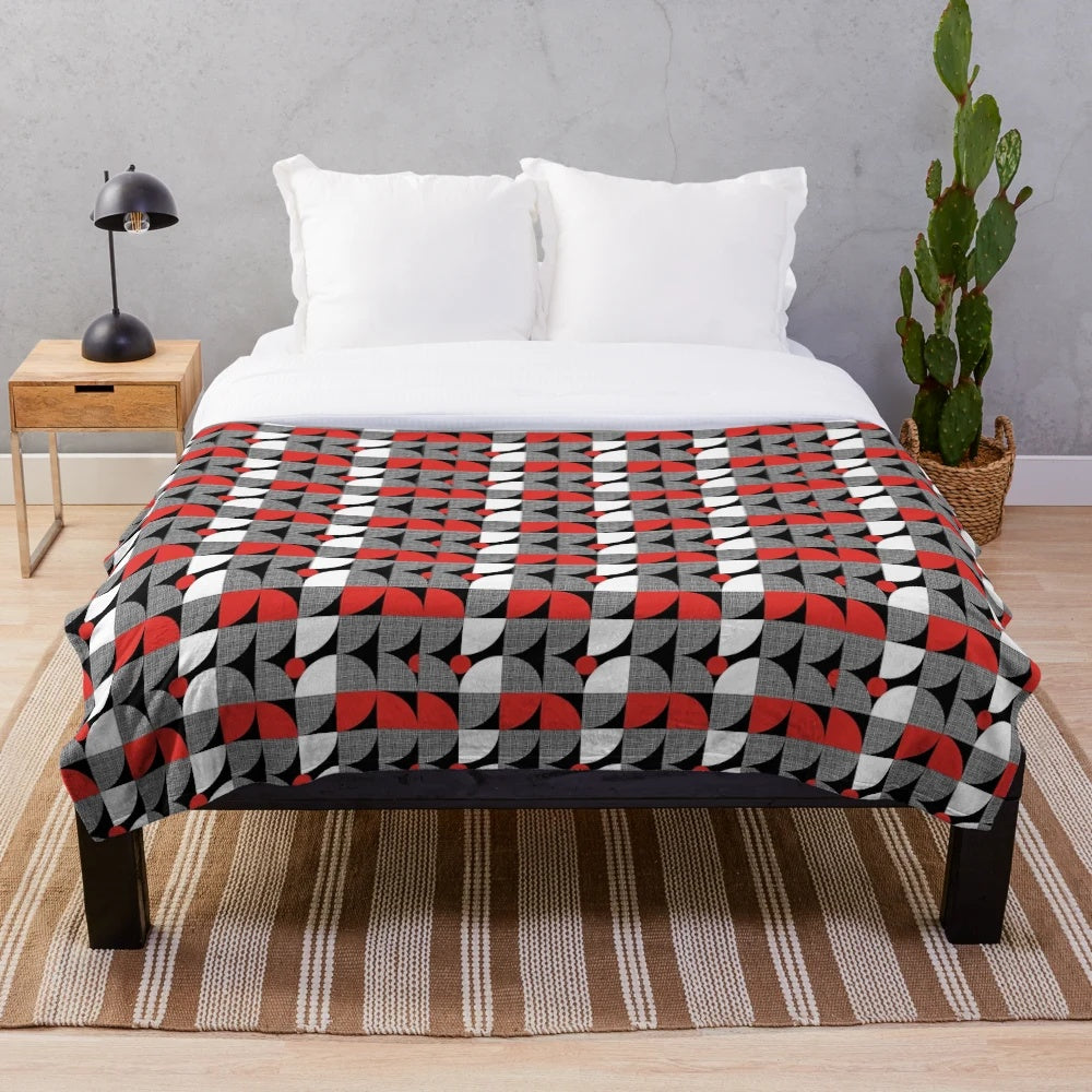 Textured mid-century style plush blanket with abstract circular design in red and black