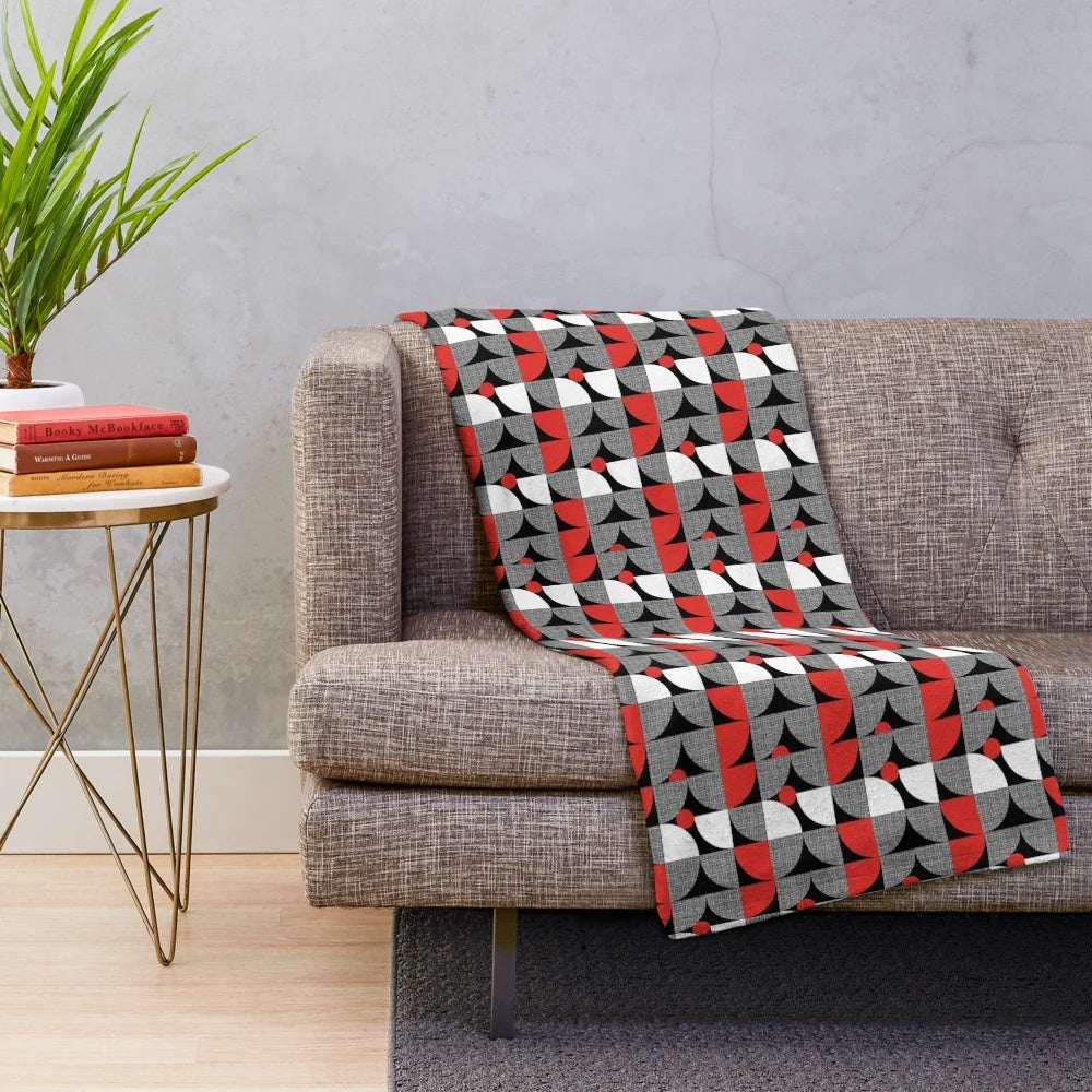 Textured mid-century style plush blanket with abstract circular design in red and black