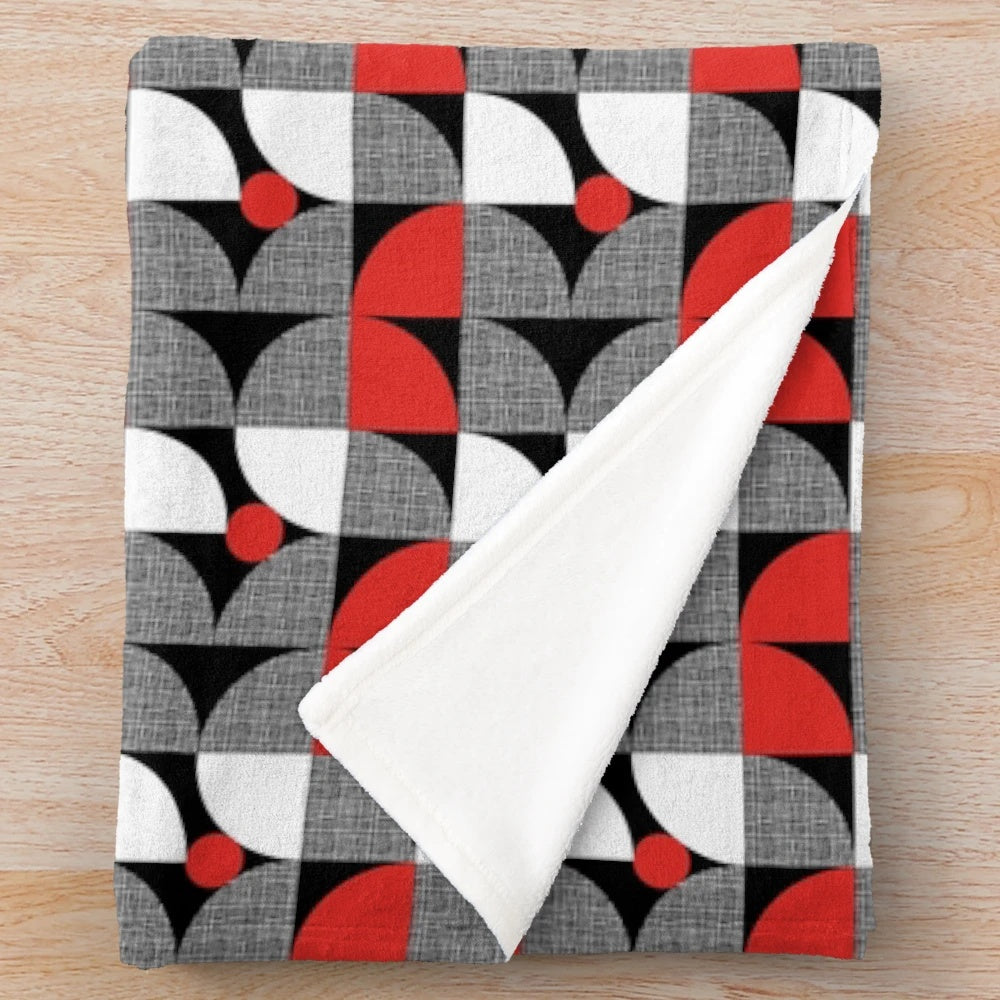 Textured mid-century style plush blanket with abstract circular design in red and black