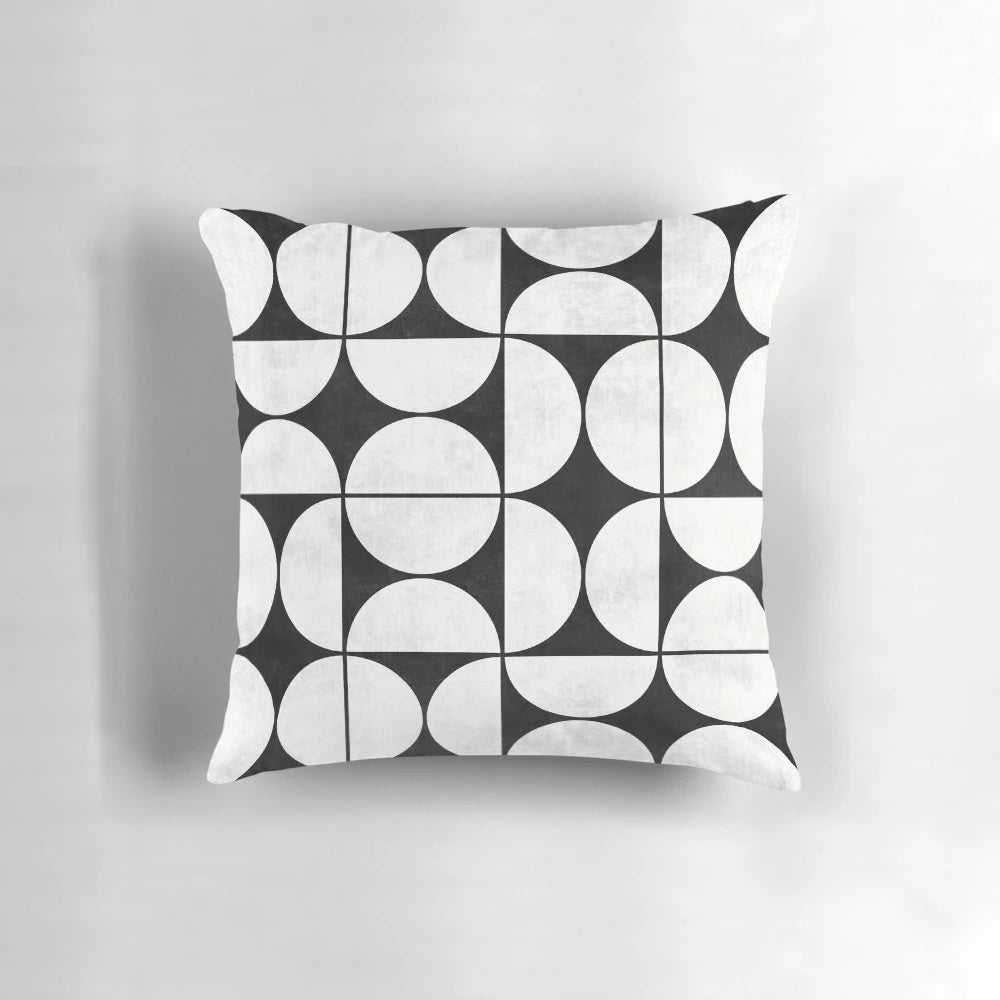 Mid-century modern black and white concrete pillow with a unique pattern of circles and half-circles