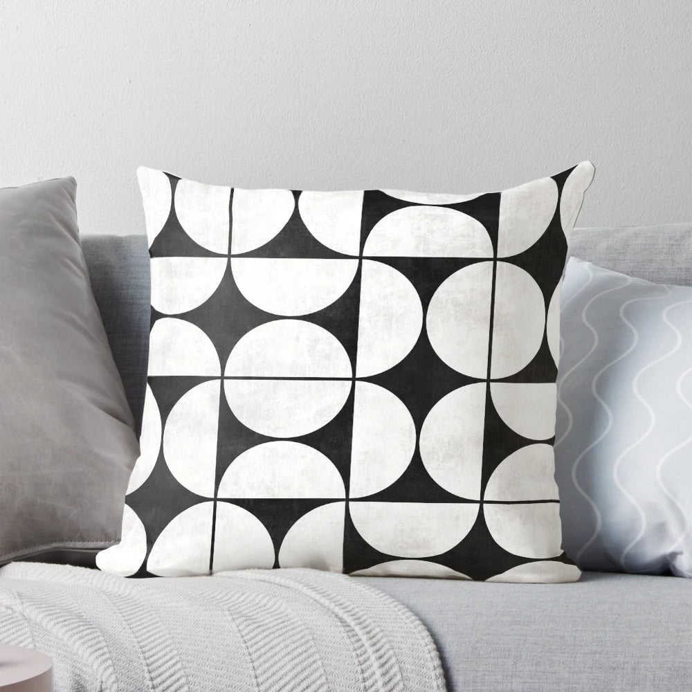 Mid-century modern black and white concrete pillow with a unique pattern of circles and half-circles
