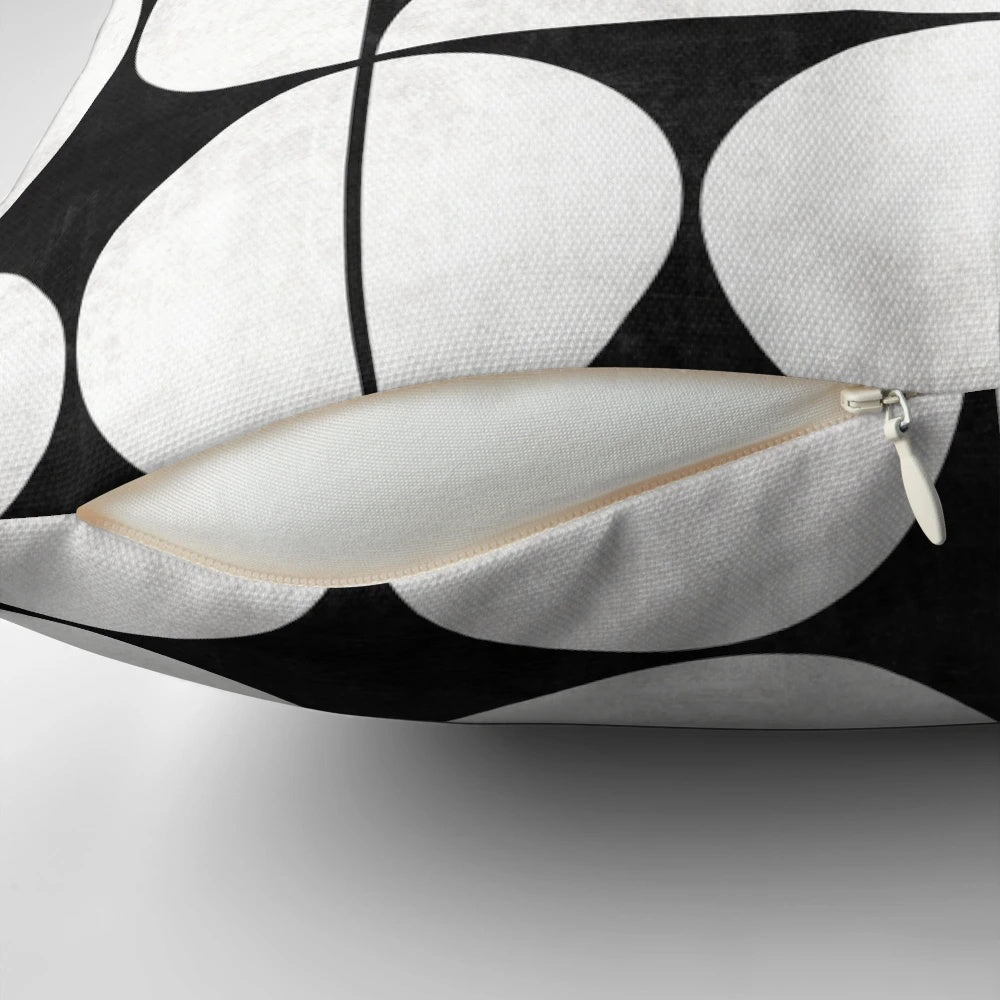 Mid-century modern black and white concrete pillow with a unique pattern of circles and half-circles