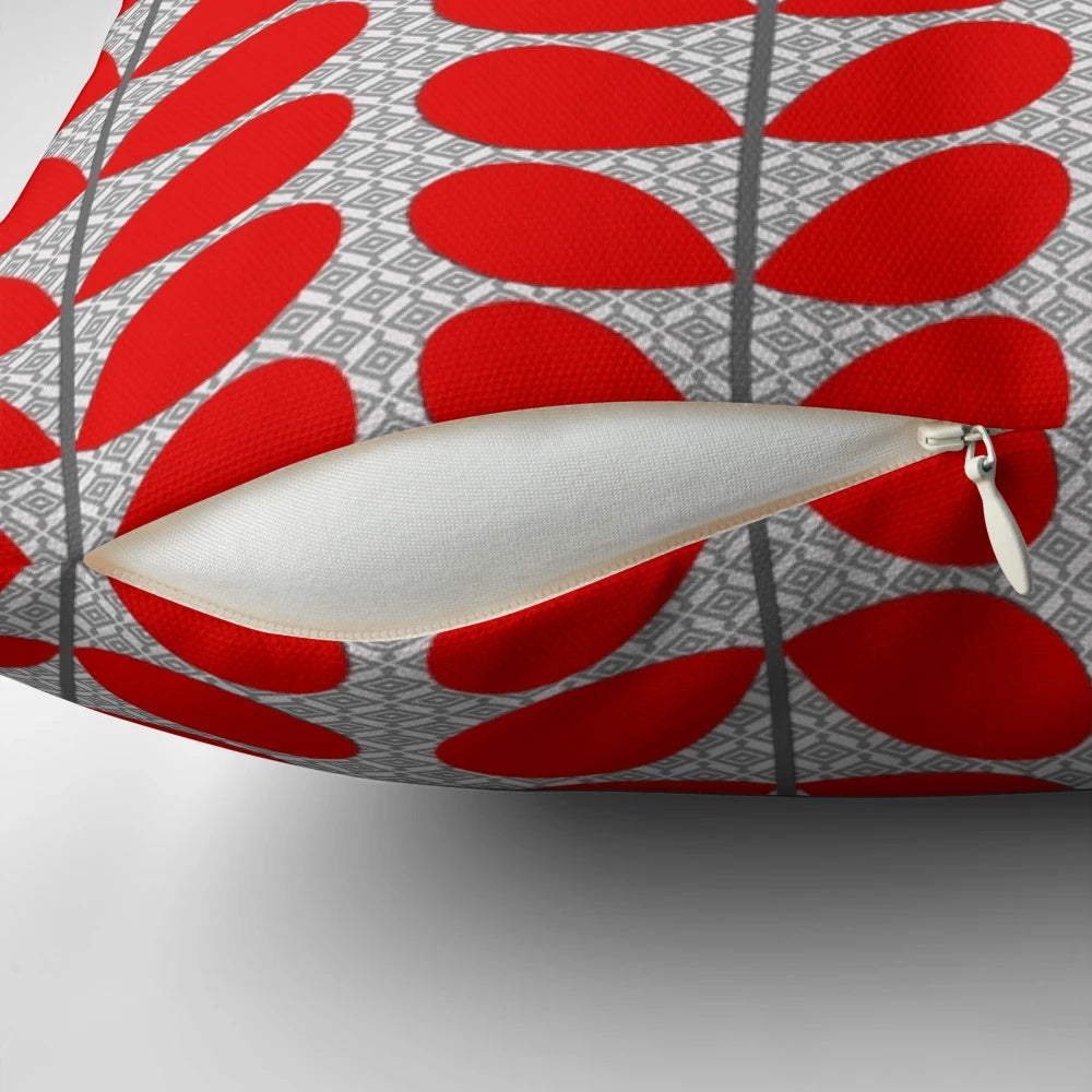 Decorative throw pillow featuring a mid-century modern abstract leaf design in a rich deep red and gray color scheme