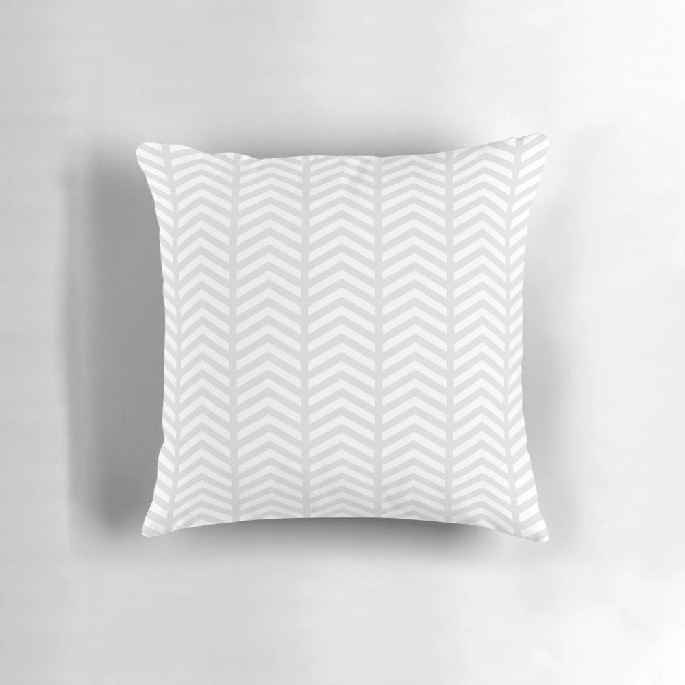 Stylish minimalist decorative pillow with a grey and white geometric chevron pattern