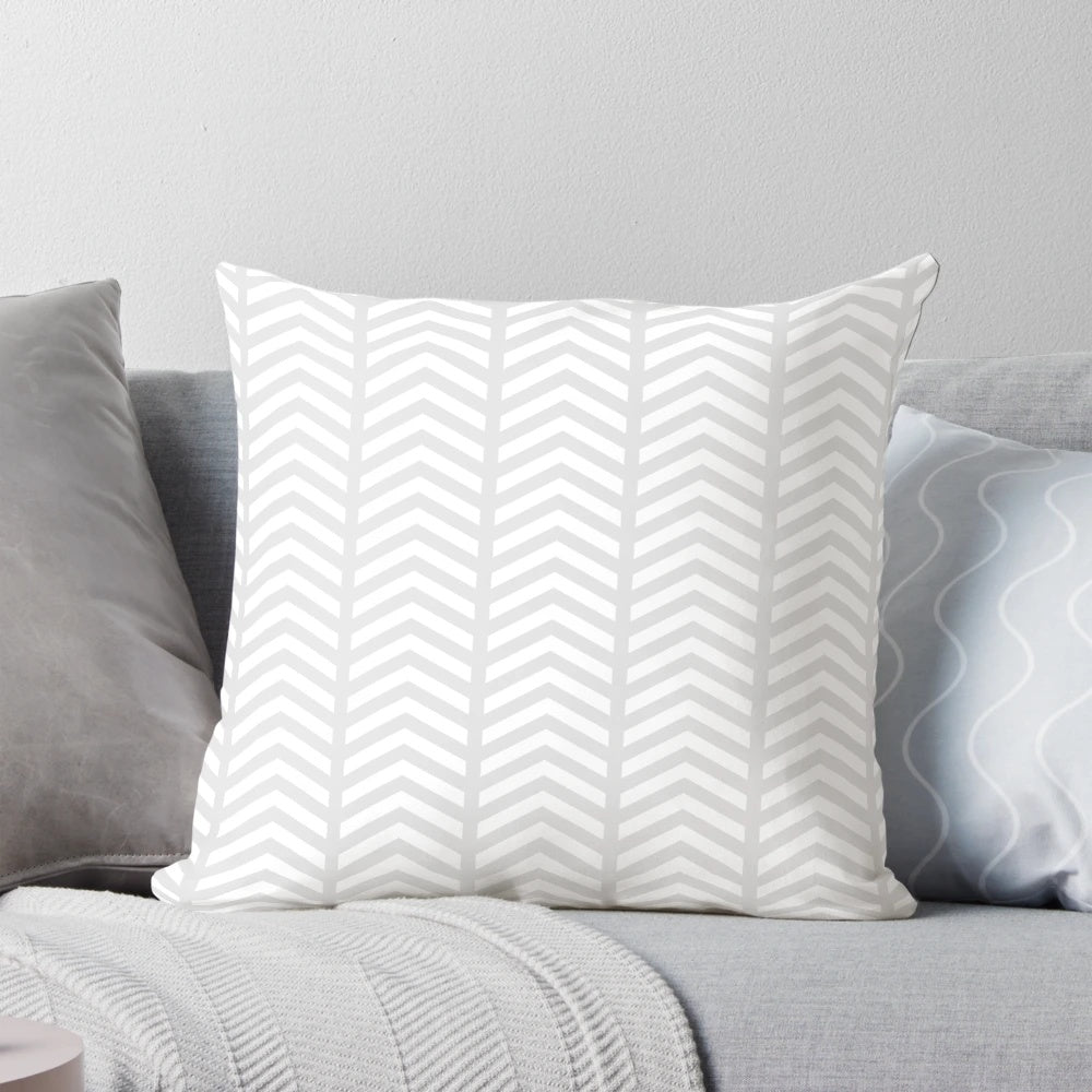 Stylish minimalist decorative pillow with a grey and white geometric chevron pattern
