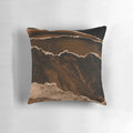 A modern abstract decorative pillow with a minimalist geode design in shades of brown and gold.