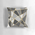 A black and gray modern geometric pillow with gold triangle patterns