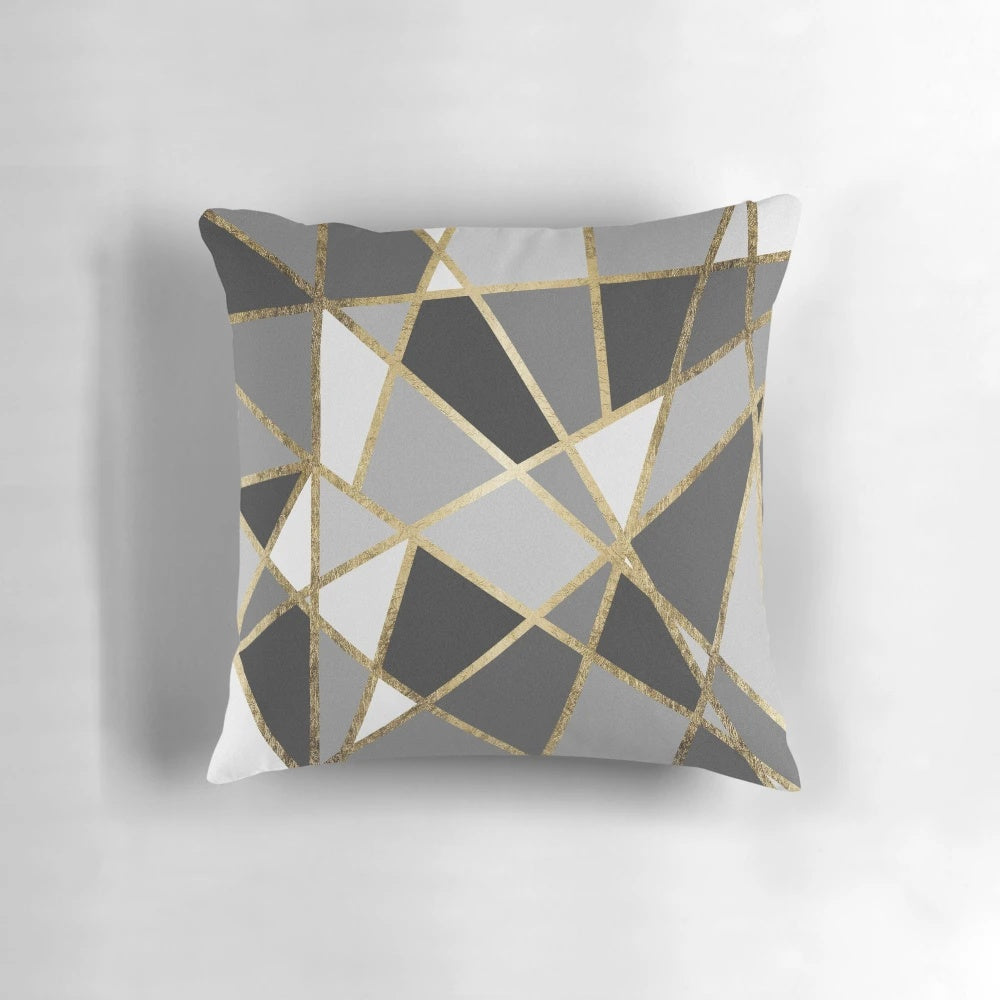A black and gray modern geometric pillow with gold triangle patterns