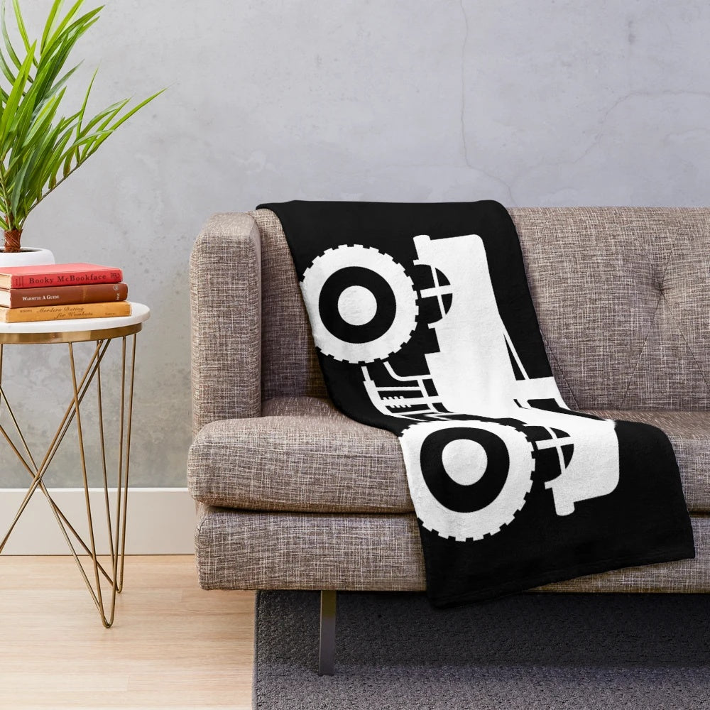Monster truck silhouette design on a plush, cozy blanket