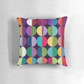 Soft, circular moon-themed pillow with a modern geometric pattern in shades of yellow, orange, blue, green, pink, and navy.