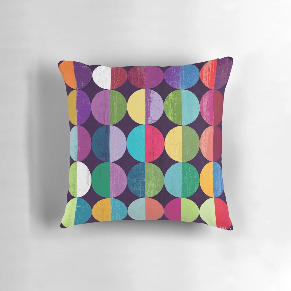 Soft, circular moon-themed pillow with a modern geometric pattern in shades of yellow, orange, blue, green, pink, and navy.