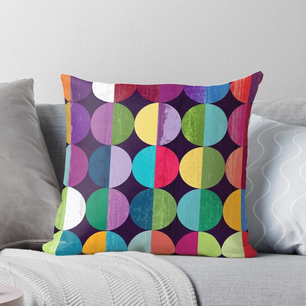 Soft, circular moon-themed pillow with a modern geometric pattern in shades of yellow, orange, blue, green, pink, and navy.