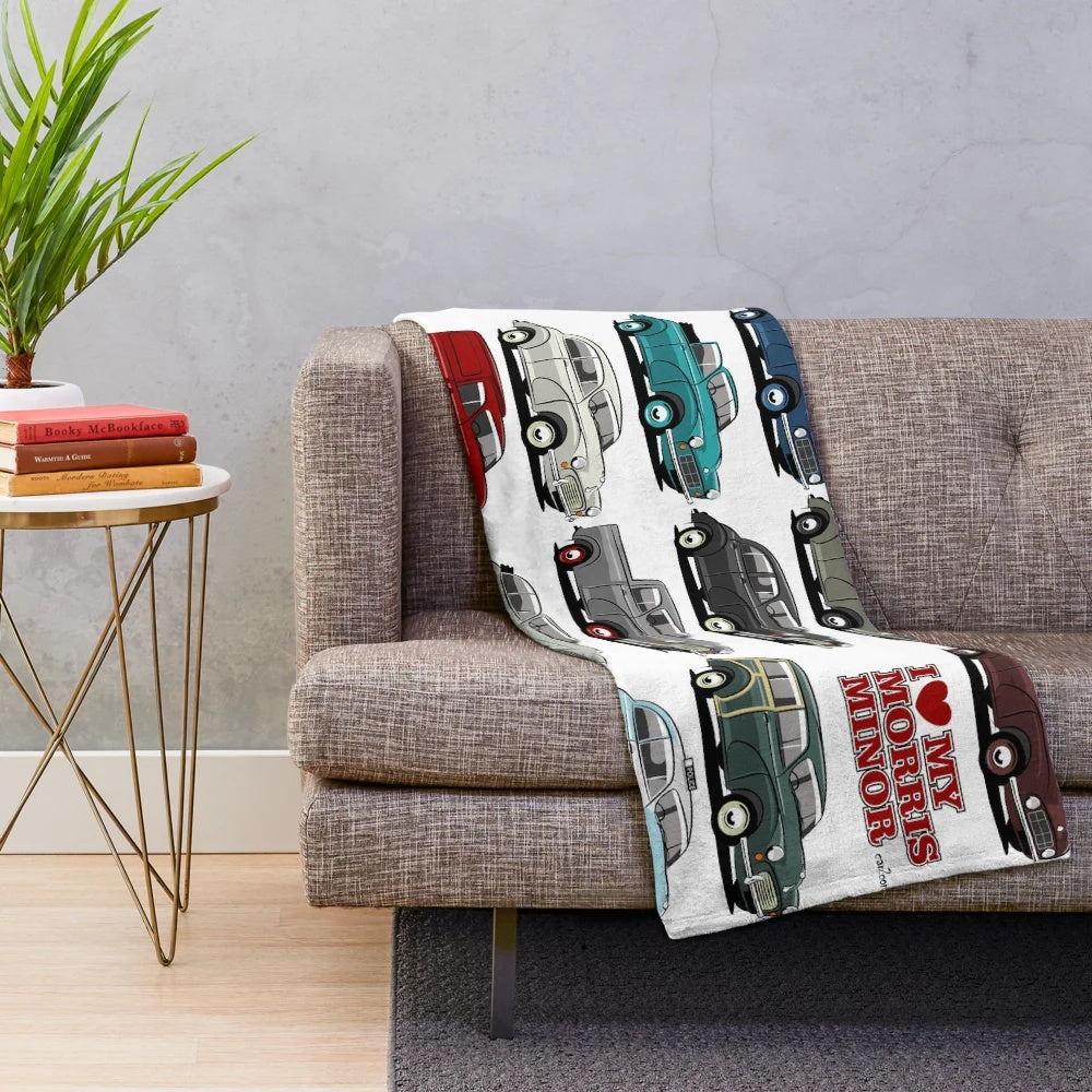 Morris Minor inspired plush blanket featuring a cartoon-style illustration of the iconic classic British car