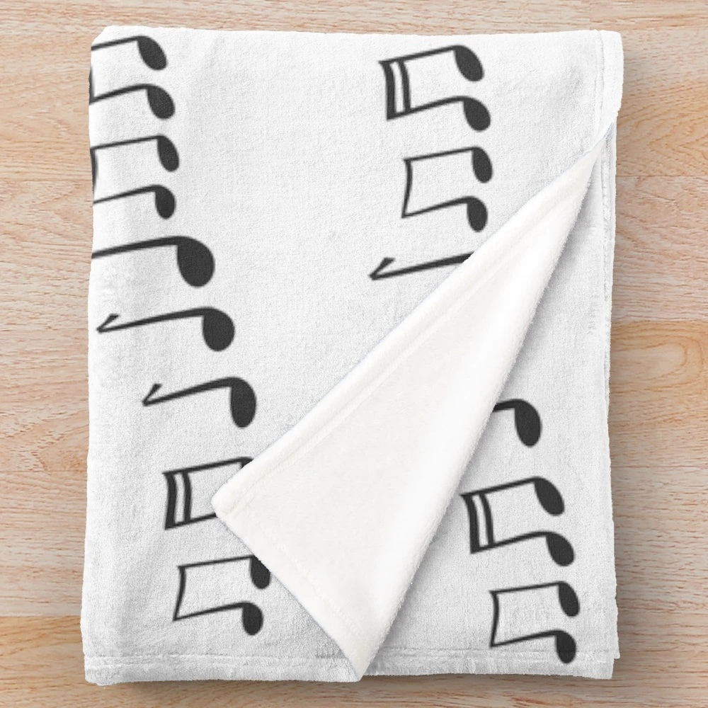 Soft and cozy plush blanket with a musical notes pattern in black and white