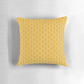 Mustard yellow pillow with geometric square pattern in a mid-century modern style