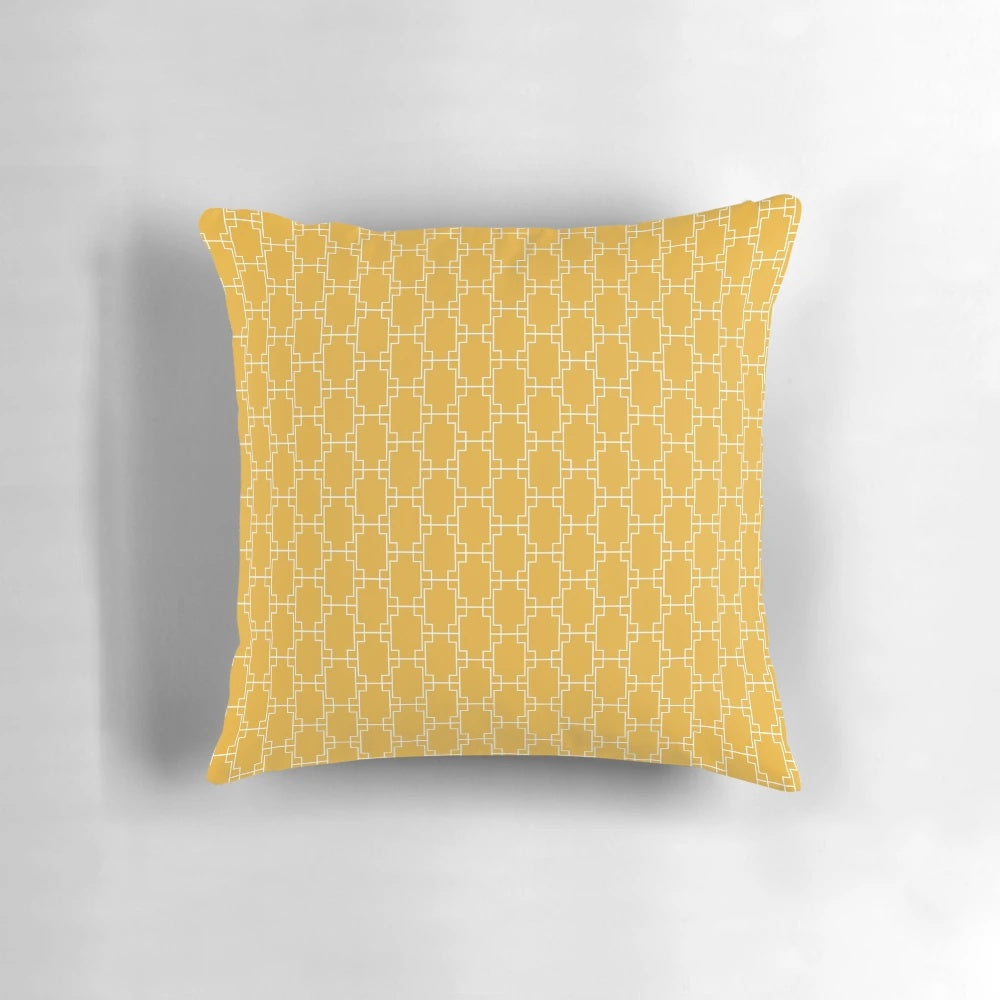 Mustard yellow pillow with geometric square pattern in a mid-century modern style