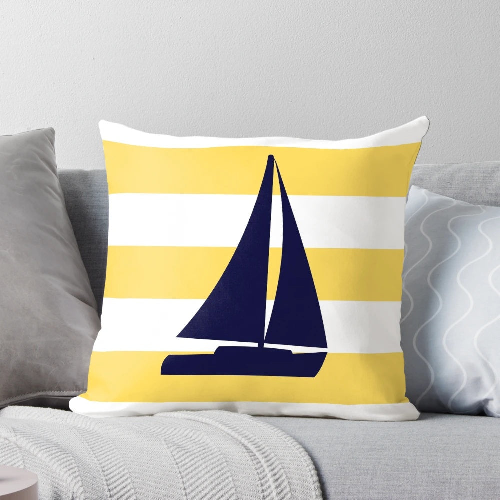A decorative navy blue and mustard yellow striped pillow with a sailboat design, perfect for coastal or nautical-themed home decor.