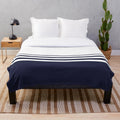 Navy and white striped plush blanket with a modern, minimalist design