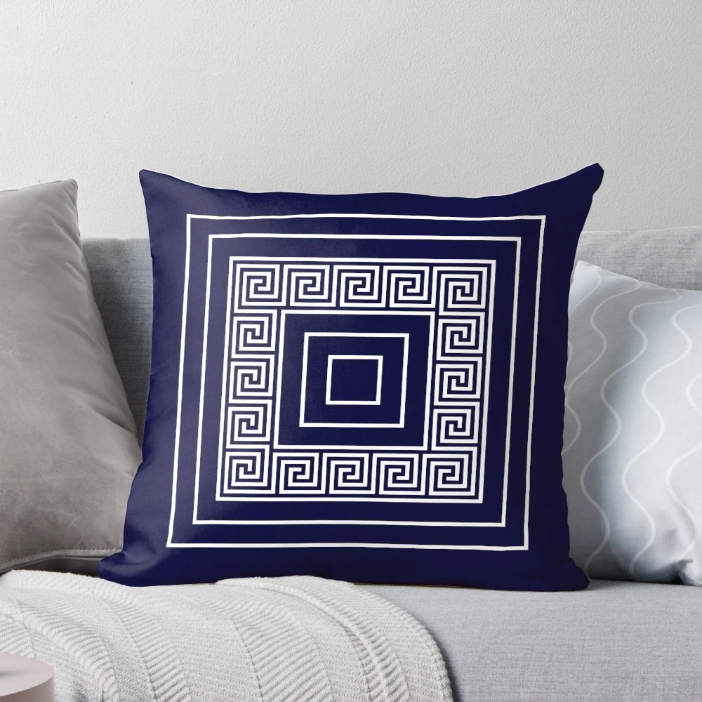 Navy blue pillow with a Greek key meander pattern and framed squares design
