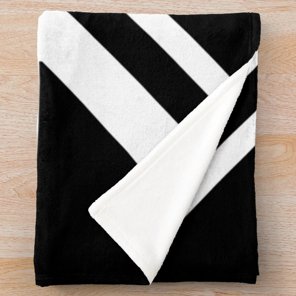 Newcastle United plush blanket featuring black and white stripes and a Union Jack flag design