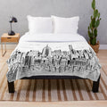 Plush blanket featuring a hand-drawn illustration of the iconic New York City skyline