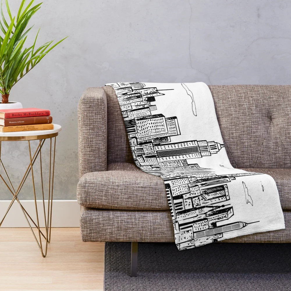 Plush blanket featuring a hand-drawn illustration of the iconic New York City skyline