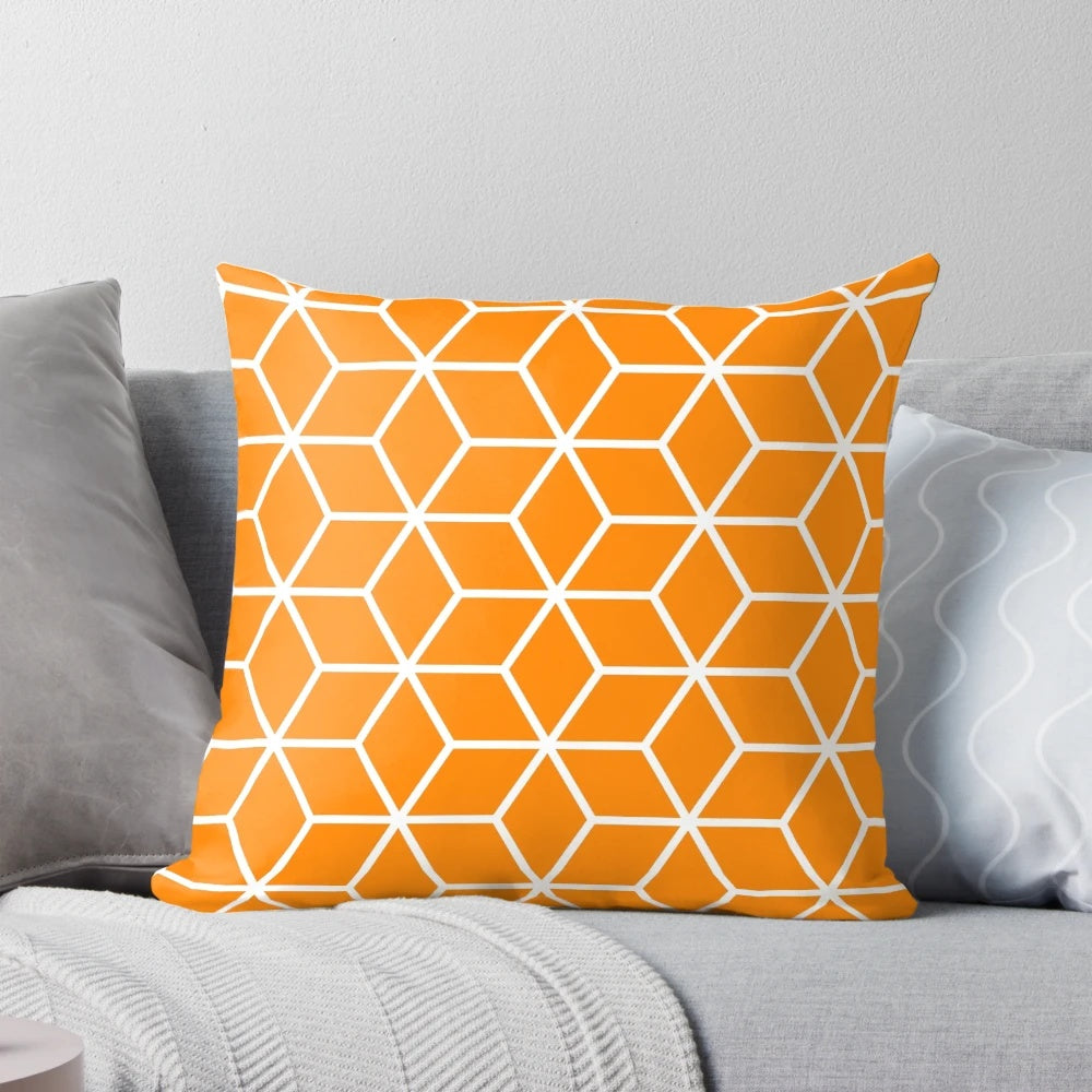 An orange, geometric, honeycomb-patterned pillow with an interlocked, lattice design.