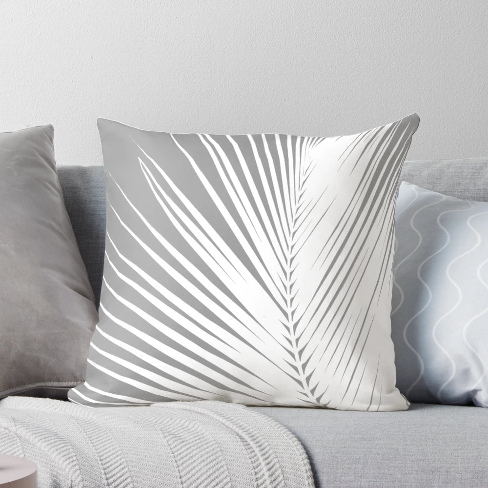 Decorative gray and white palm leaf throw pillow for coastal home decor