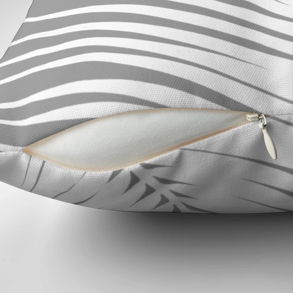 Decorative gray and white palm leaf throw pillow for coastal home decor