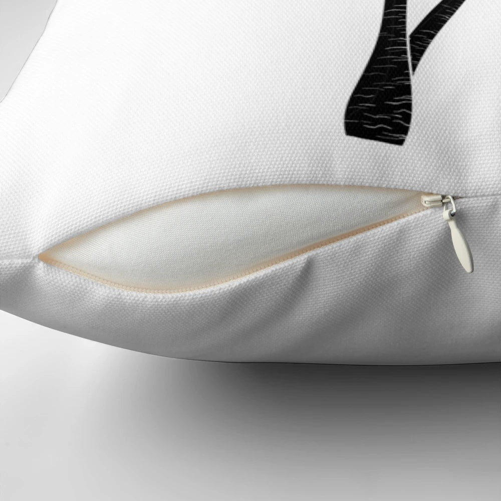 A monochrome palm tree design on a minimalist pillow