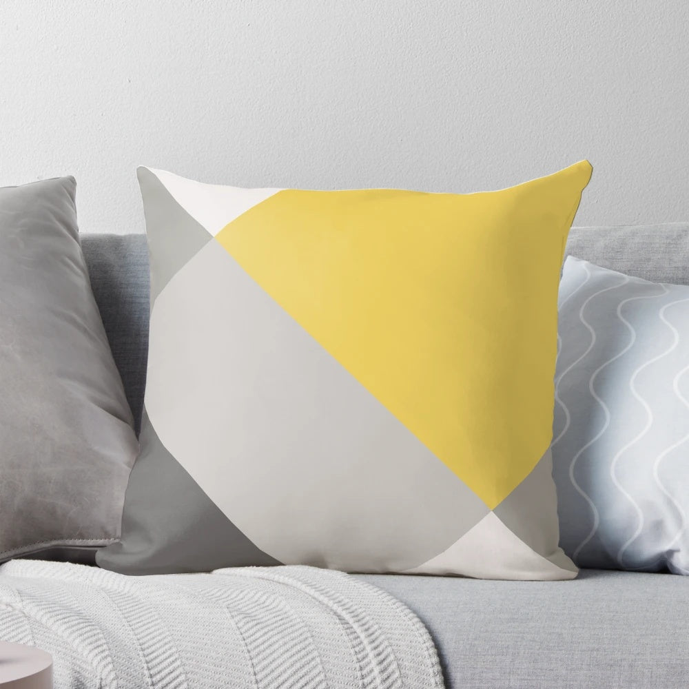 Patchwork pillow in mustard yellow and grey colors, featuring a modern, geometric design