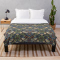 Patterned plush blanket featuring the iconic Strawberry Thief design by renowned British artist William Morris