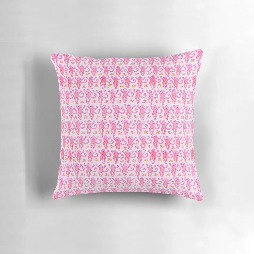 A soft, vibrant pink pillow featuring a whimsical monkey design, perfect for adding a touch of preppy style to any space.