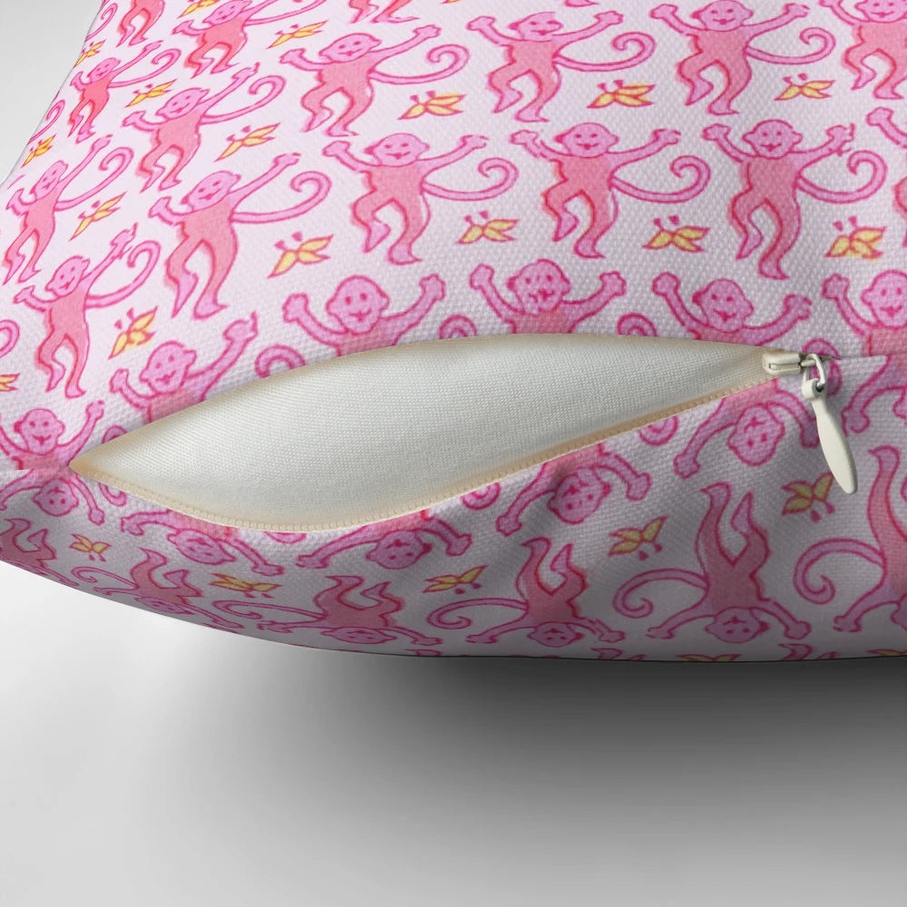 A soft, vibrant pink pillow featuring a whimsical monkey design, perfect for adding a touch of preppy style to any space.