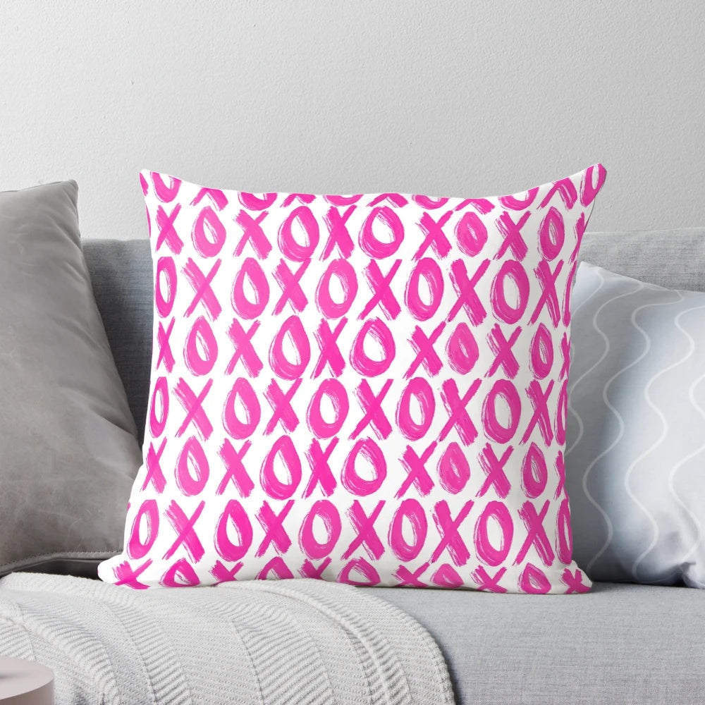 Soft, plush pink pillow with a delicate xoxo print design