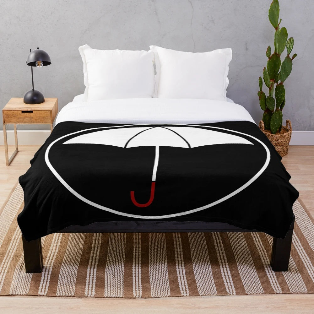 Cozy white plush blanket featuring the iconic umbrella design from The Umbrella Academy Netflix series