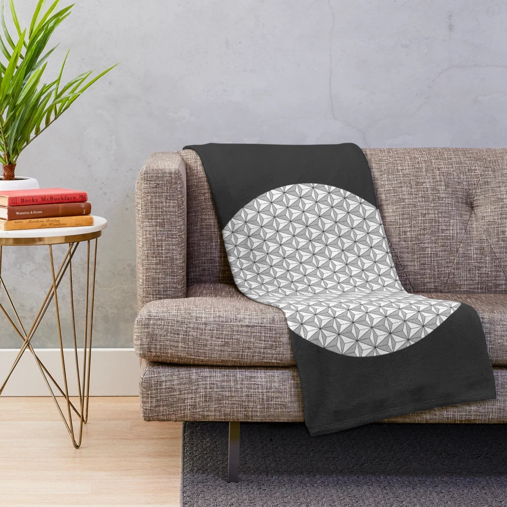 Stylish plush blanket featuring a geometric spaceship earth design